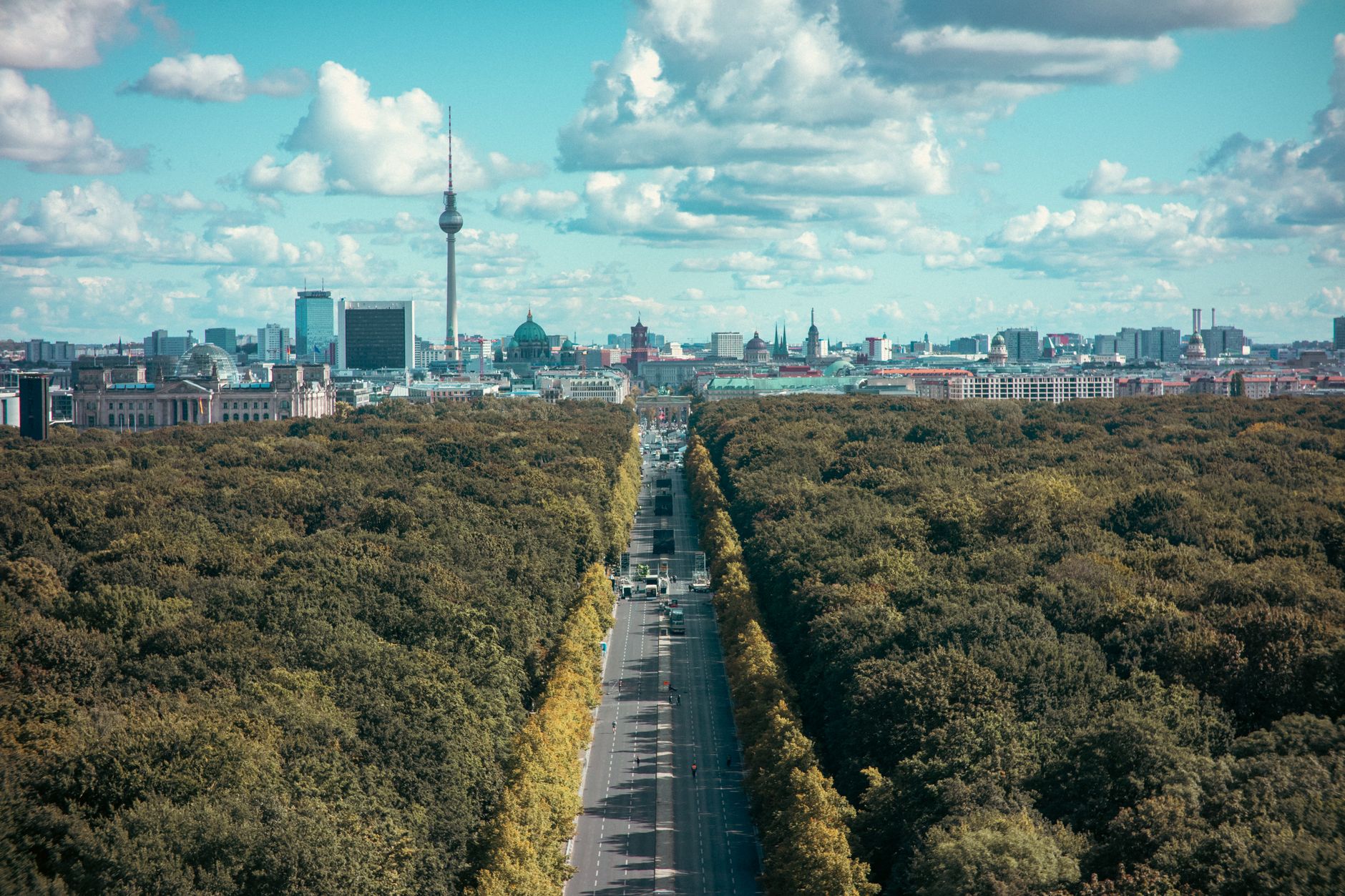 Aerial view of Berlin's skyline and Tiergarten with TV tower on a bright day.