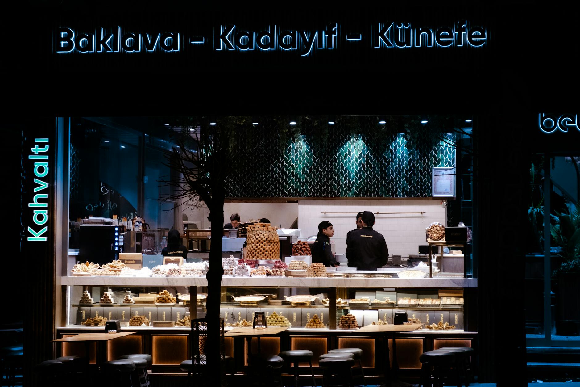 Night view of a bakery café showcasing traditional sweets with illuminated display.