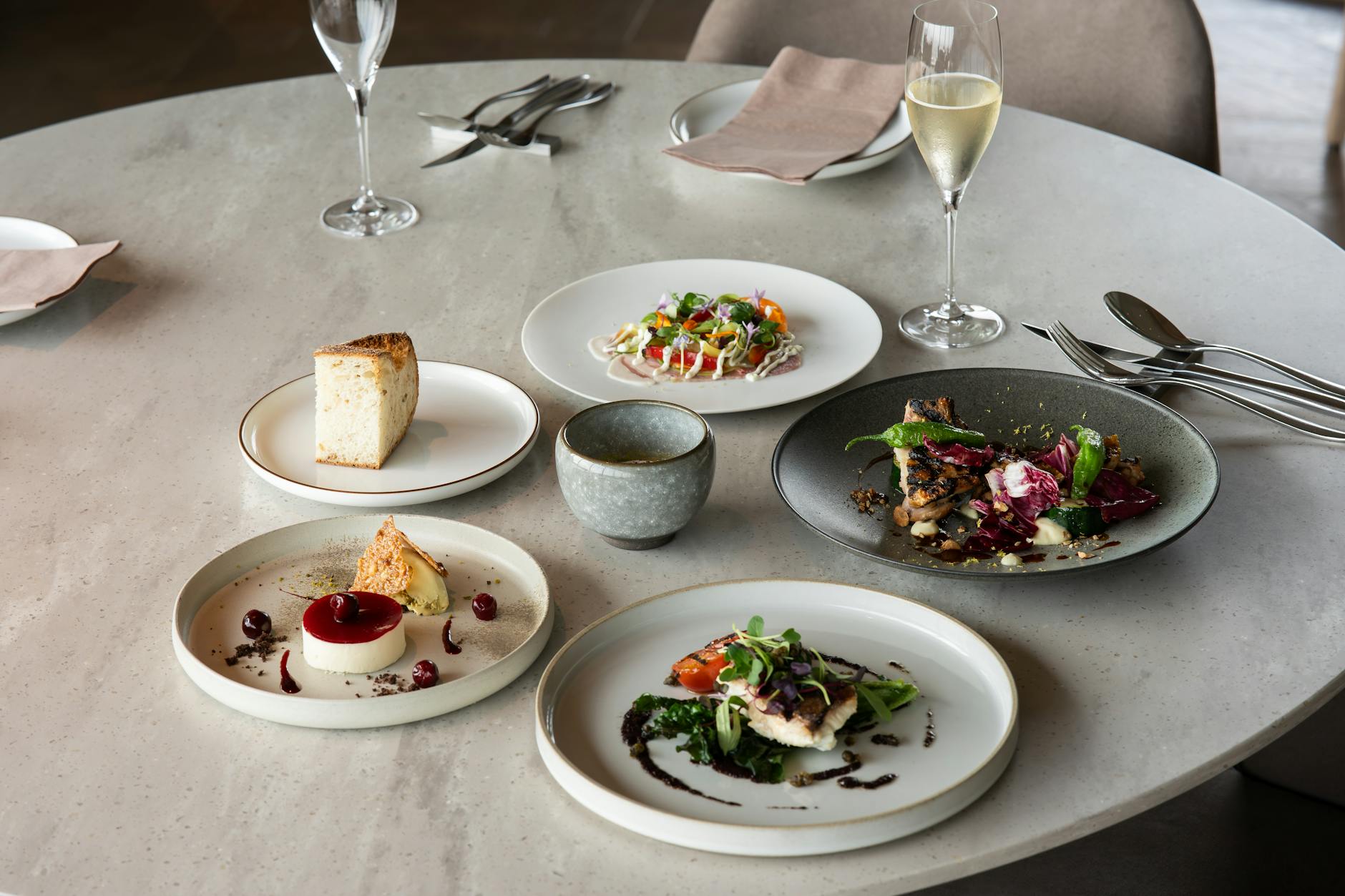 Elegant fine dining setup with gourmet dishes and wine in Tokyo, Japan.