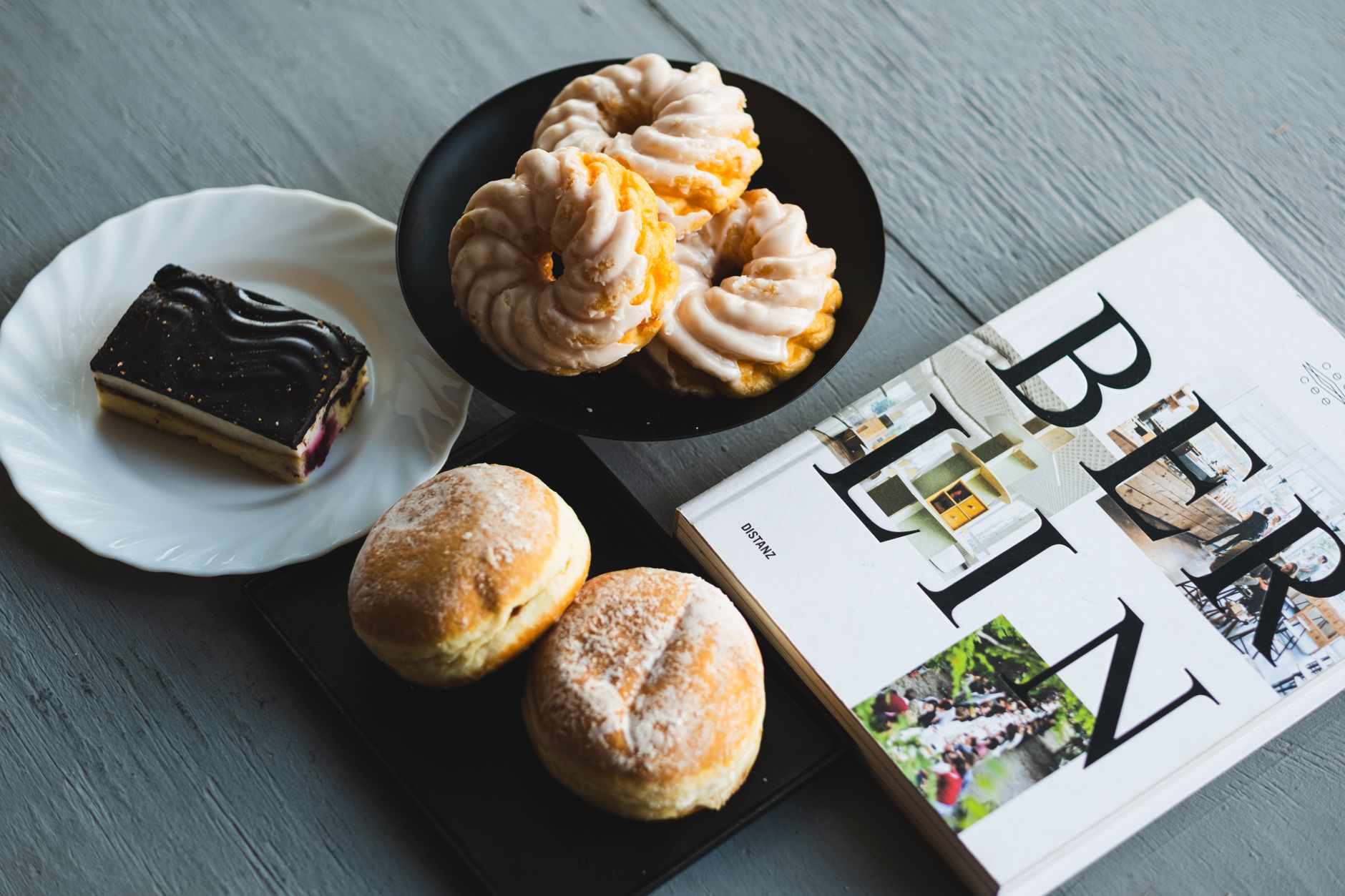 A selection of German sweets and pastries with a Berlin magazine, perfect for a cozy breakfast.